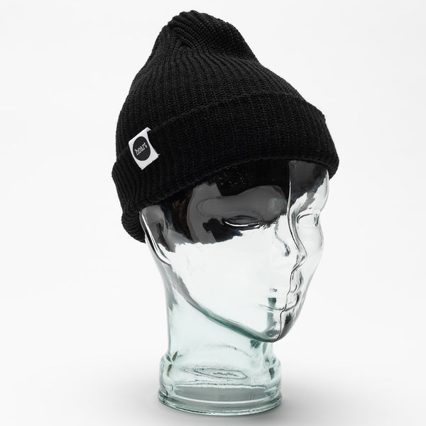 black heart beanie hat with small white tag with heart logo. styled on a glass head against a white backdrop.